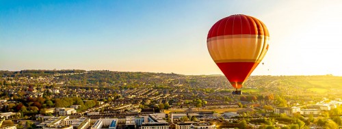 Rush of hot air balloon above the city of Bath
