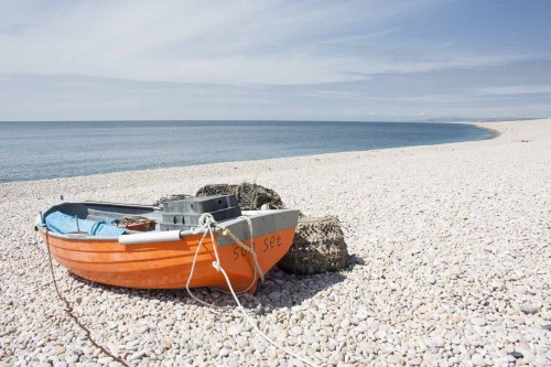 An orange boat on Chesil Beach