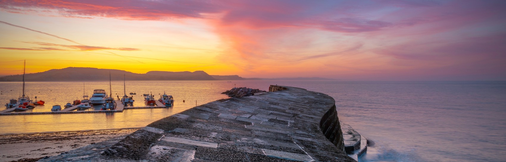 Sunrise over The Cob in Lyme Regis. Photograph by ADRIAN BAKER